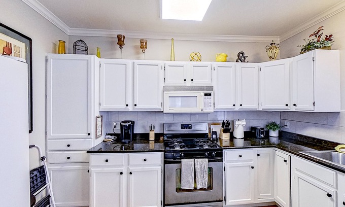 Midtown House | Inviting duplex with full kitchen, patio, central AC, & W/D
