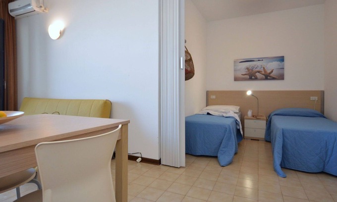 Lignano Sabbiadoro Apartment | Lovely apartment for 4 guests with pool, A/C, TV, terrace, pets allowed and parking