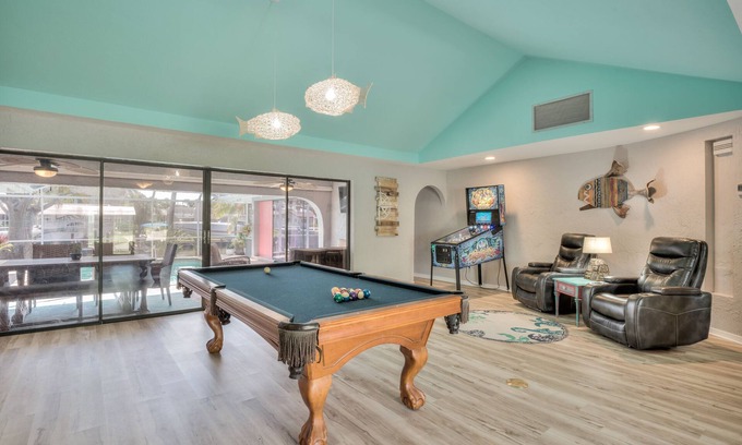 Yacht Club House | Lovely Canal Home in SW Cape with heated pool, game room, and a tiki on the dock