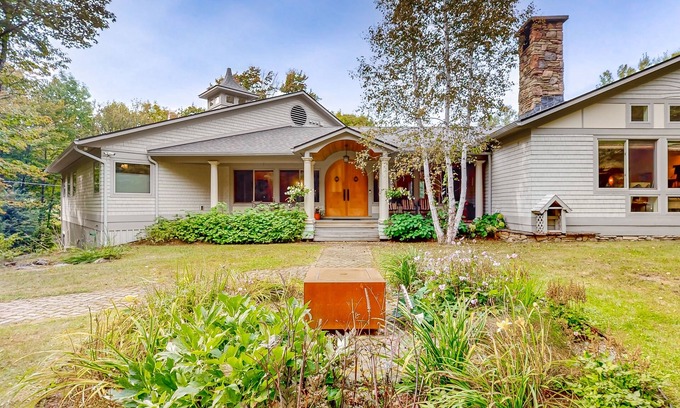 Warren House | Luxe custom home with hot tub, game room, & beautiful garden