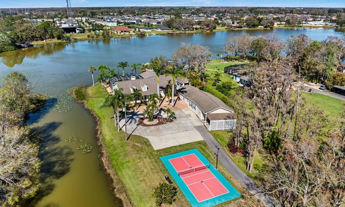 Westchase House | Luxe Waterfront Hideaway w Pool & Pirate Ship Dock
