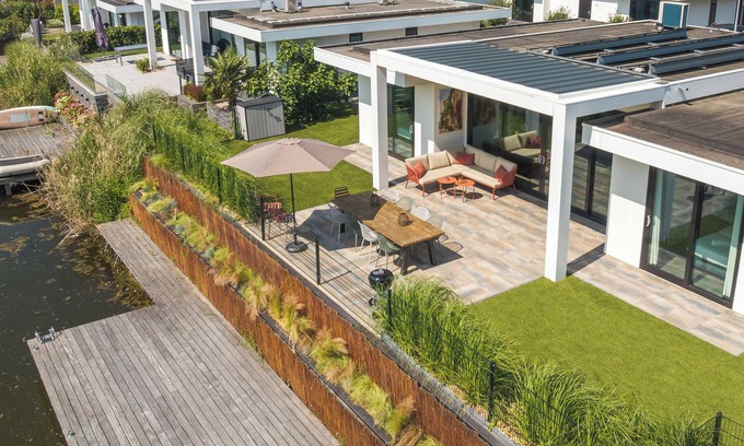 Zeewolde House | Modern 8-person waterfront villa with fenced garden, private jetty, spacious open living area and full comfort for families – pets welcome.