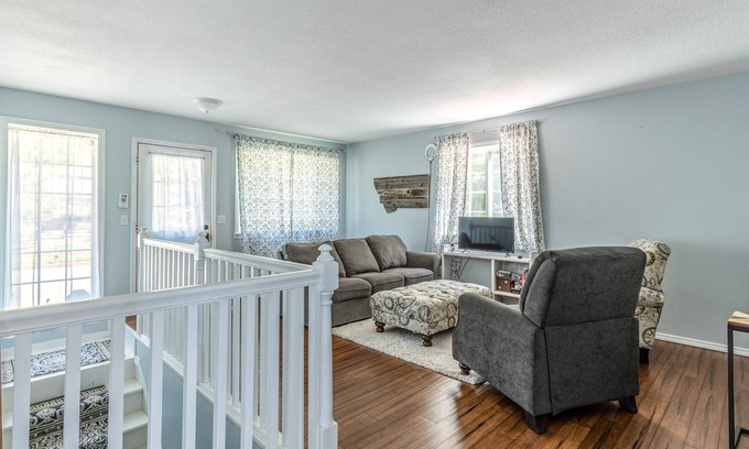 Woods Bay House | Mountain-view home with large deck, gas grill, firepit, lawn, and central AC