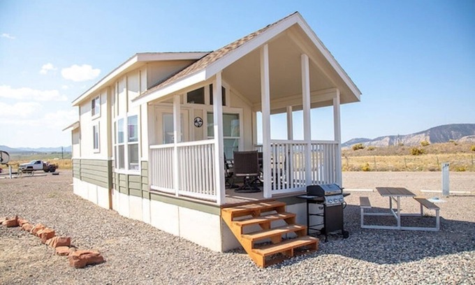 Meeker House | Our largest "not so tiny" tiny home, White River Casita is a beautiful modern tiny home that features a Queen bed on main level, one Queen bed in loft accessible by stairs, one Queen fold out couch with additional sleeping space in loft for sleeping