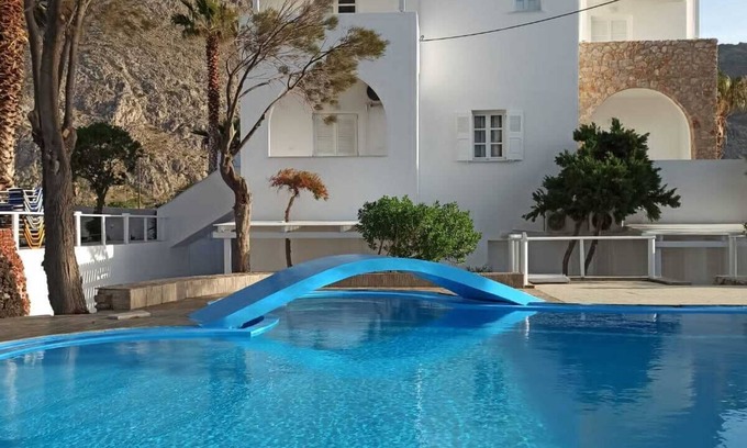 Perissa House | Relaxing environment under trees with a swimming pool, a pool bar.