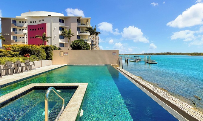 Maroochydore Apartment | Relaxing Escape: Pool, Tennis Court, Garden Terrace & Water Views