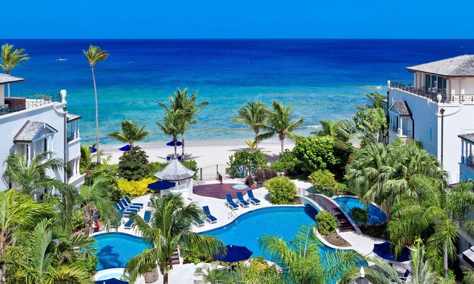 Schooner Bay Apartment | Schooner bay is a beachfront condominium with a freeform swimming pool as the focal point