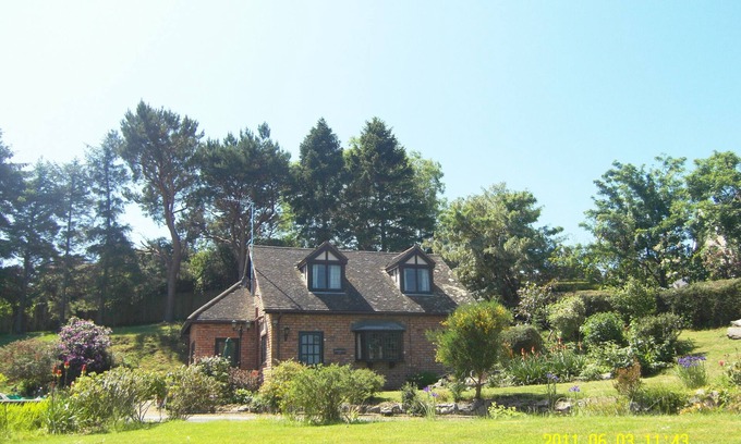 Colwyn Bay House | Seaview from bedroom, lounge and bathroom within an acre garden of tennis court