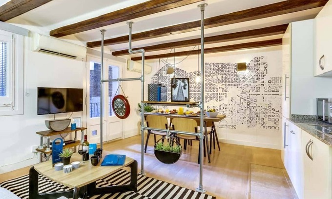 La Nova Esquerra de l'Eixample Apartment | This modern and thoughtfully designed loft combines industrial charm with warm, cozy comfort, creating the perfect atmosphere for a memorable stay.