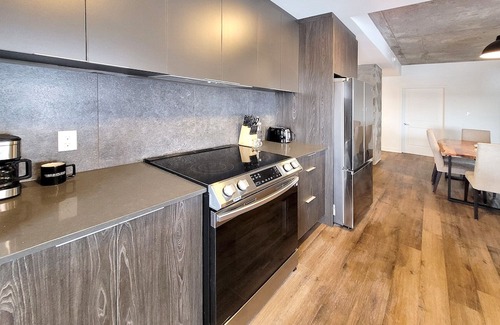 Fabreville Apartment | Corporate Stays - Elegant 3BR with Rooftop, Gym & Lounge