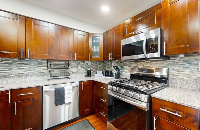 Dog-friendly home with fenced yard, furnished patio, washer/dryer, & AC