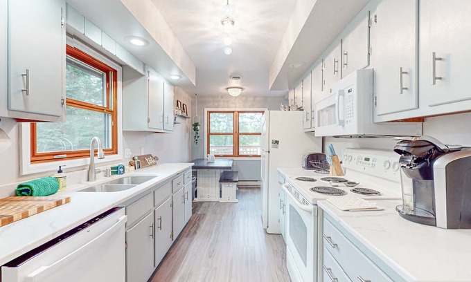 Hazelhurst House | Lakefront home with large patio, fire pit, air hockey & a provided peddle boat